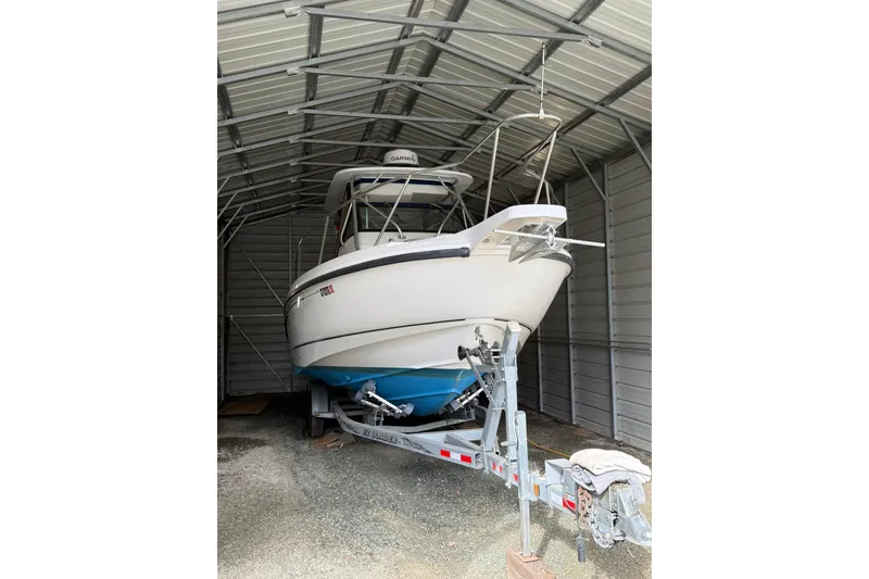 Slide: The Image of 2000 Boston Whaler 28 Outrage boat stored in a metal shelter on a trailer. - 3