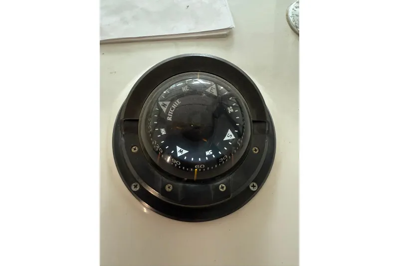 Slide: The Image of Compass on 2000 Boston Whaler 28 Outrage boat dashboard. - 30