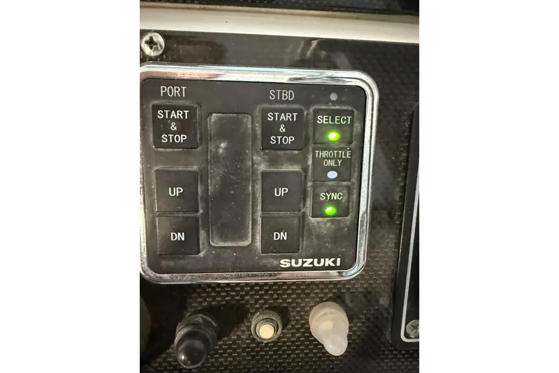 Slide: The Image of Control panel of a 2000 Boston Whaler 28 Outrage boat with Suzuki engine controls. - 34