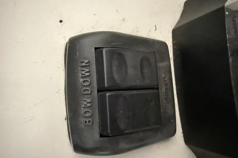 Slide: The Image of Trim tab control labeled "Bow Down" on a 2000 Boston Whaler 28 Outrage boat. - 36