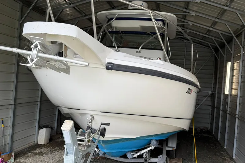 Slide: The Image of 2000 Boston Whaler 28 Outrage boat stored in a metal shed. - 4
