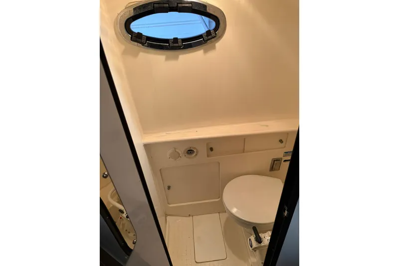Slide: The Image of Interior of 2000 Boston Whaler 28 Outrage boat bathroom with porthole window. - 41
