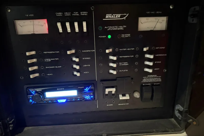 Slide: The Image of Control panel of a 2000 Boston Whaler 28 Outrage boat with various switches and gauges. - 42
