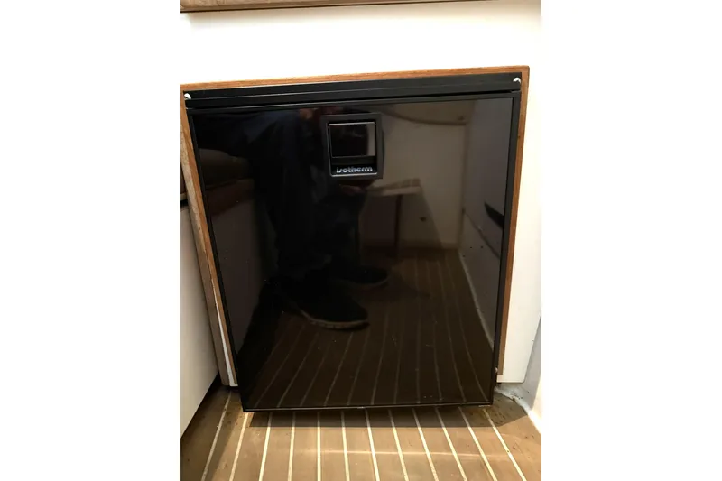 Slide: The Image of Black refrigerator on a 2000 Boston Whaler 28 Outrage boat interior. - 47