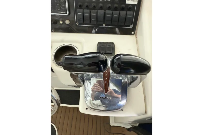 Slide: The Image of Throttle controls on a 2000 Boston Whaler 28 Outrage boat, featuring Suzuki branding. - 55
