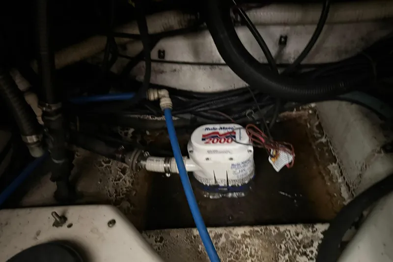 Slide: The Image of Bilge area of a 2000 Boston Whaler 28 Outrage with pump and wiring visible. - 57