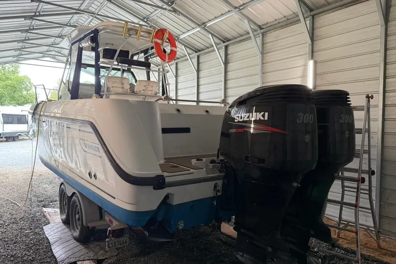 Slide: The Image of 2000 Boston Whaler 28 Outrage with Suzuki engines in a covered storage area. - 6