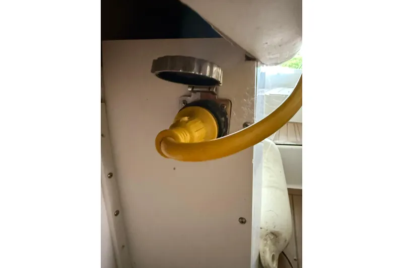 Slide: The Image of Yellow power cable connected to a 2000 Boston Whaler 28 Outrage boat. - 60