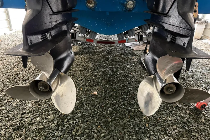 Slide: The Image of Twin propellers of a 2000 Boston Whaler 28 Outrage on gravel surface. - 9