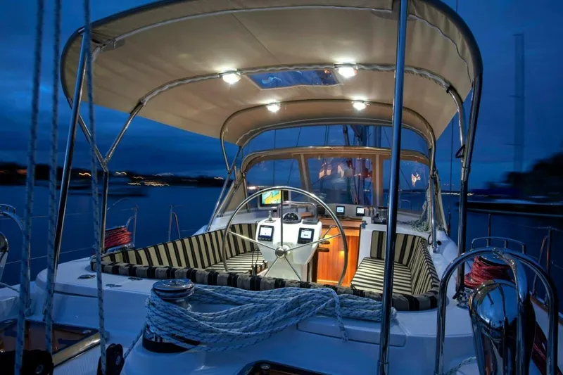 Slide: The Image of Luxurious 2025 Hylas H48 yacht cockpit at dusk, featuring elegant seating and modern navigation equipment. - 10