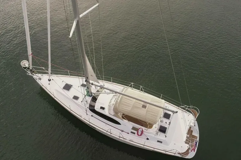 Slide: The Image of 2025 Hylas H48 yacht sailing on calm waters, aerial view. - 3