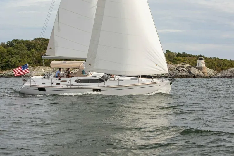 Slide: The Image of Sailing yacht Hylas H48 (2025) on water near a lighthouse, with American flag. - 7