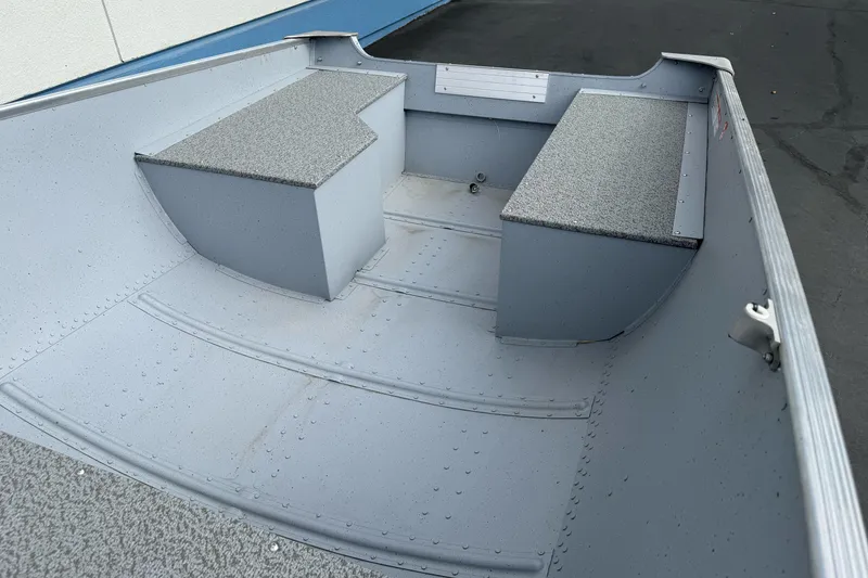 Slide: The Image of 2026 Lund WC 12 boat interior with gray seating and aluminum finish. - 4