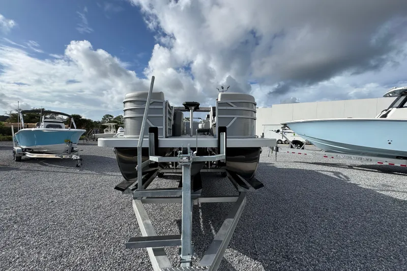 Slide: The Image of 2026 Bennington 22 SSR pontoon boat on trailer under cloudy sky. - 11