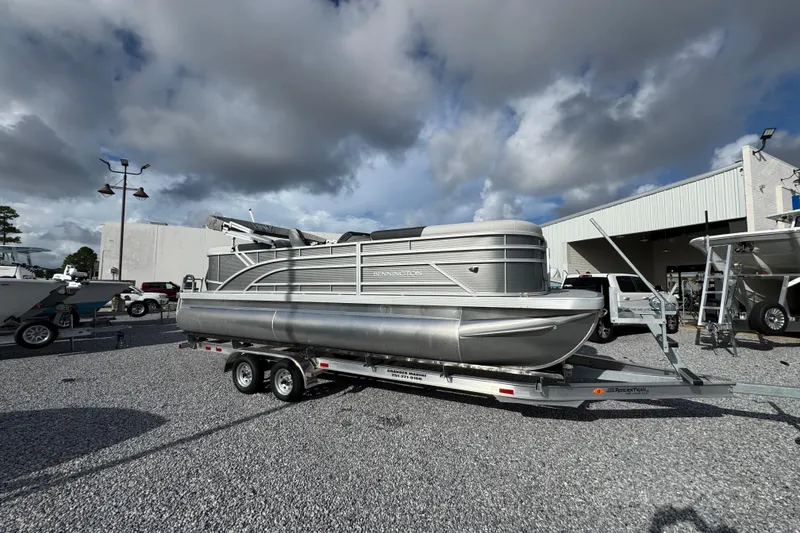 Slide: The Image of 2026 Bennington 22 SSR pontoon boat on trailer under cloudy sky. - 14