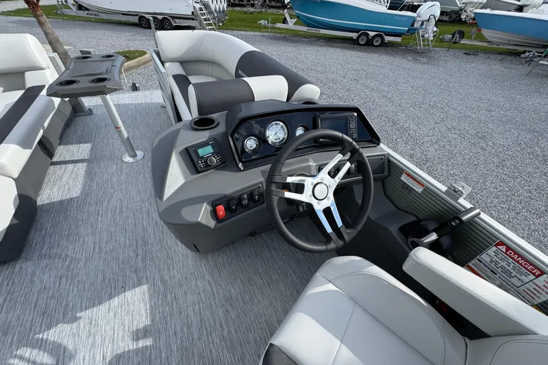 Slide: The Image of 2026 Bennington 22 SSR boat interior with steering wheel and seating area. - 18