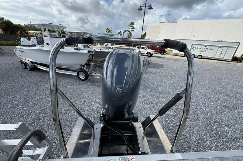 Slide: The Image of Outboard motor on a 2026 Bennington 22 SSR boat, parked on gravel. - 24