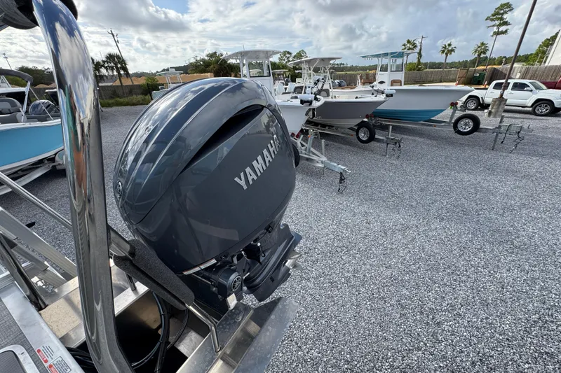 Slide: The Image of 2026 Bennington 22 SSR with Yamaha outboard motor in a boatyard. - 25