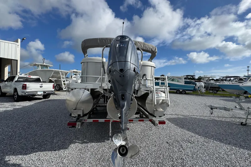 Slide: The Image of 2026 Bennington 22 SSR pontoon boat with outboard motor in a marina under blue skies. - 5