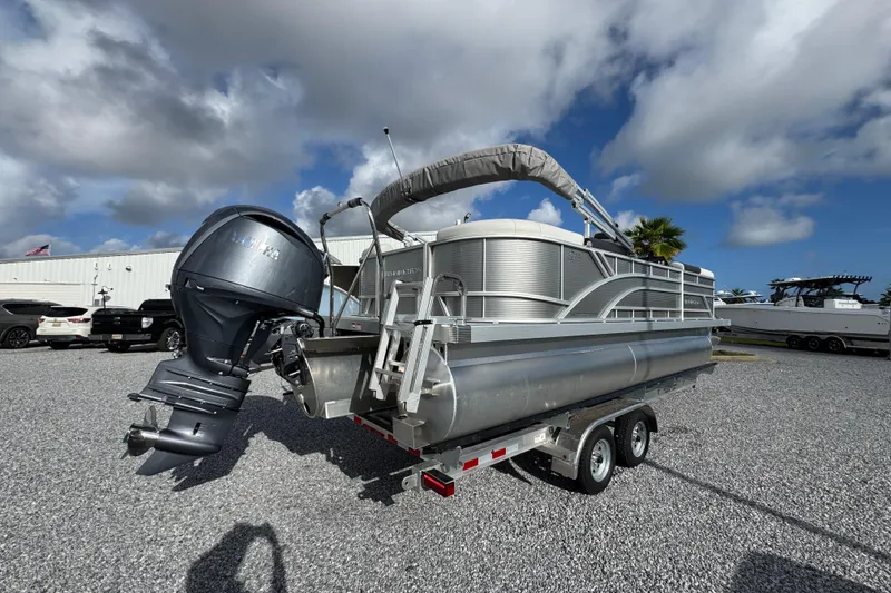 Slide: The Image of 2026 Bennington 22 SSR pontoon boat on trailer under cloudy sky. - 7