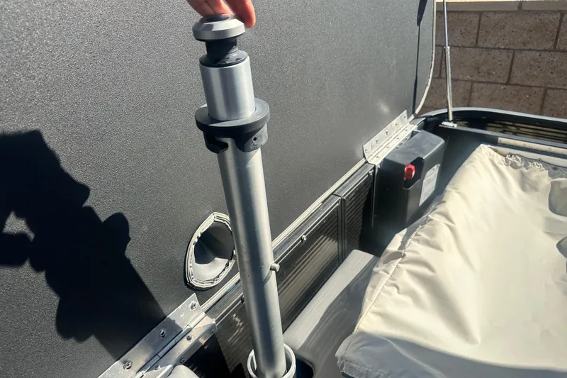 Slide: The Image of 2022 Bennington LX 24 L-Bench boat detail showing adjustable pole and seating area. - 16