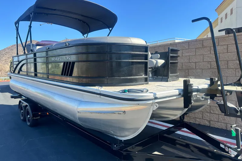 Slide: The Image of 2022 Bennington LX 24 L-Bench boat seats, featuring luxurious gray upholstery. - 9