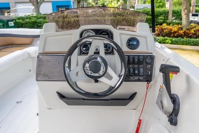 Slide: The Image of 2021 Starcraft SVX 191 OB boat dashboard with steering wheel and control panel. - 13