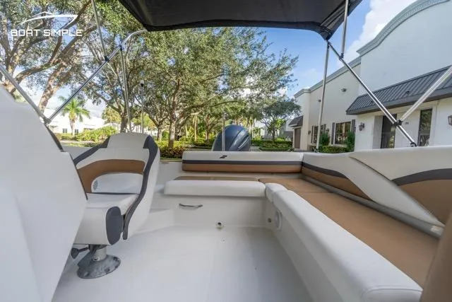 Slide: The Image of 2021 Starcraft SVX 191 OB boat interior with seating, canopy, and outdoor view. - 6