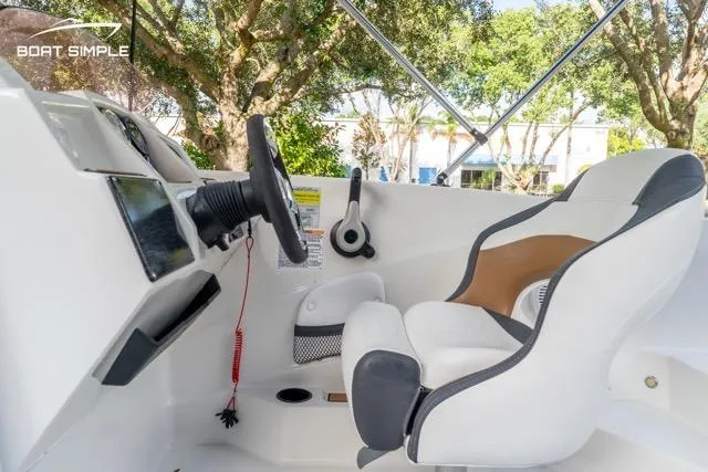Slide: The Image of 2021 Starcraft SVX 191 OB boat interior with steering wheel and captain's chair. - 9