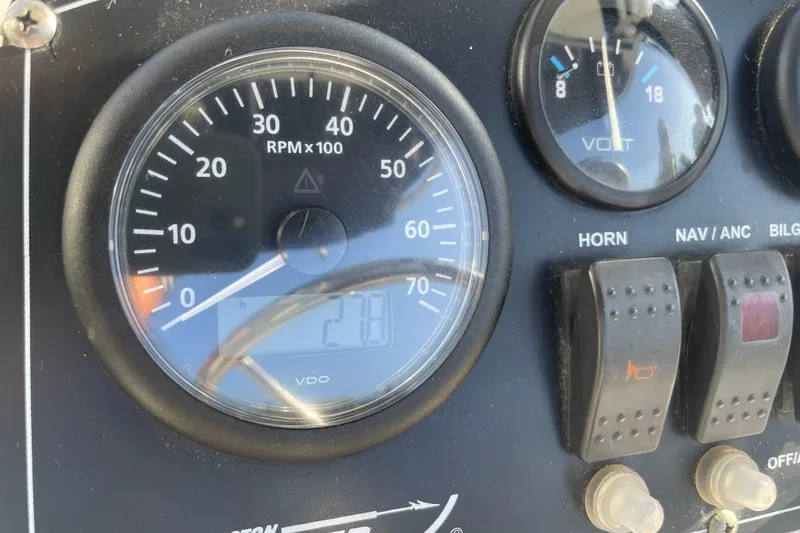 Slide: The Image of Dashboard of a 2006 Boston Whaler 170 Montauk boat with RPM and volt gauges. - 11