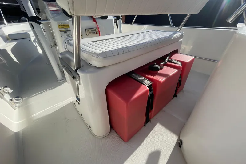 Slide: The Image of 2006 Boston Whaler 170 Montauk interior with red fuel tanks under seat. - 14