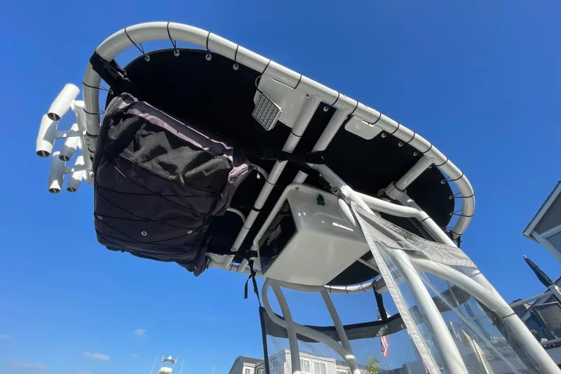 Slide: The Image of Boston Whaler 170 Montauk 2006 boat canopy against clear blue sky. - 21