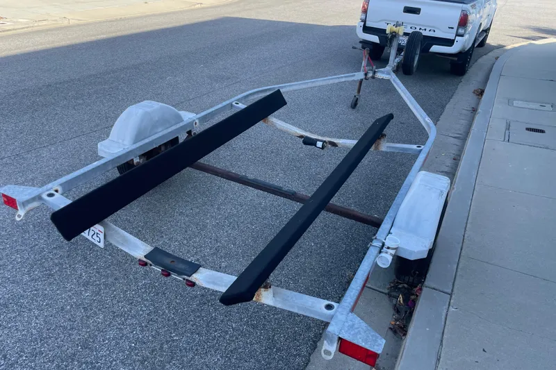 Slide: The Image of Boat trailer for 2006 Boston Whaler 170 Montauk, parked on street. - 22