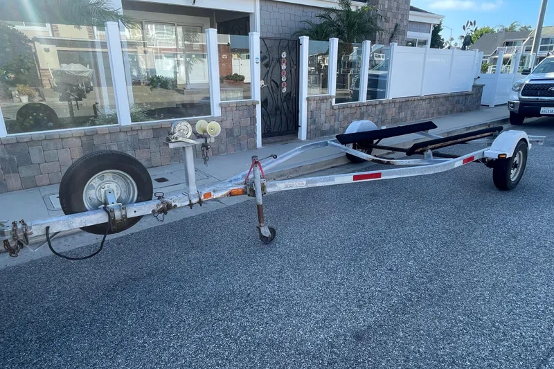 Slide: The Image of Boat trailer for 2006 Boston Whaler 170 Montauk parked on street. - 24