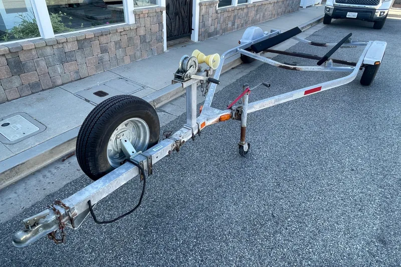 Slide: The Image of Boat trailer for 2006 Boston Whaler 170 Montauk parked on street. - 25