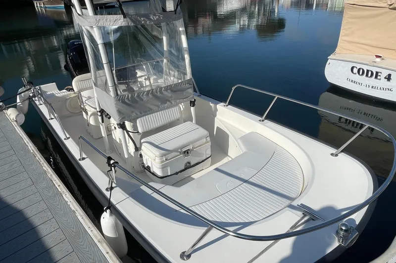 Slide: The Image of 2006 Boston Whaler 170 Montauk boat docked on calm water. - 5