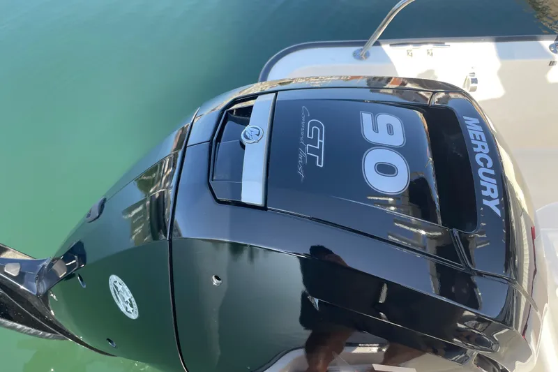 Slide: The Image of Outboard motor on a 2006 Boston Whaler 170 Montauk boat, featuring a Mercury 90 engine. - 8