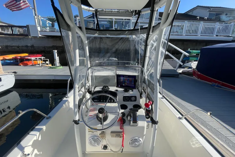 Slide: The Image of 2006 Boston Whaler 170 Montauk boat cockpit with steering wheel and navigation equipment. - 9