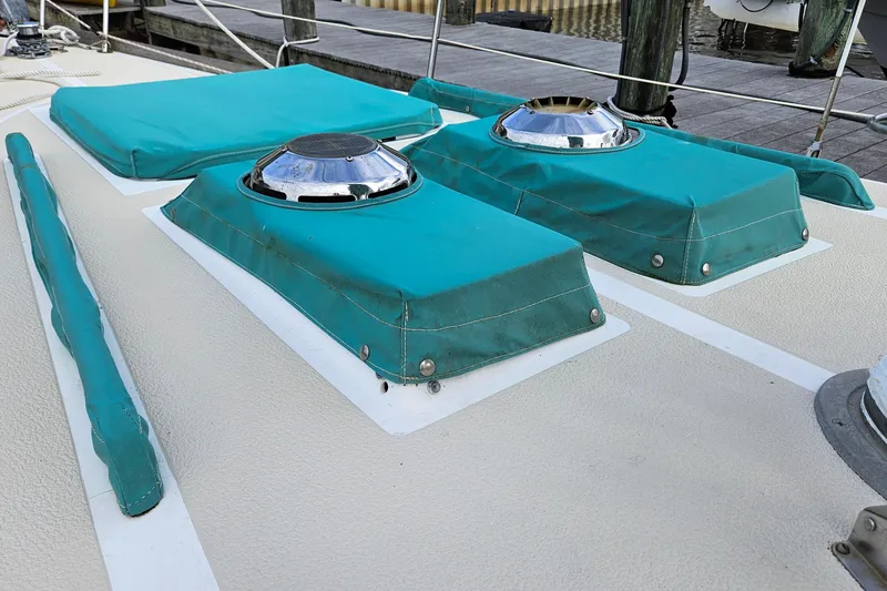 Slide: The Image of 1987 Tartan 37 sailboat deck with teal covers and chrome vents. - 11