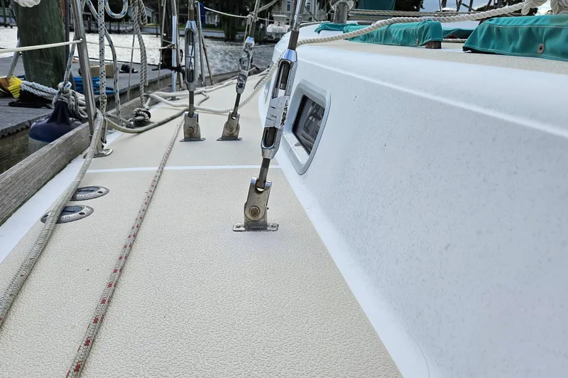 Slide: The Image of 1987 Tartan 37 sailboat deck with rigging and ropes in marina setting. - 14