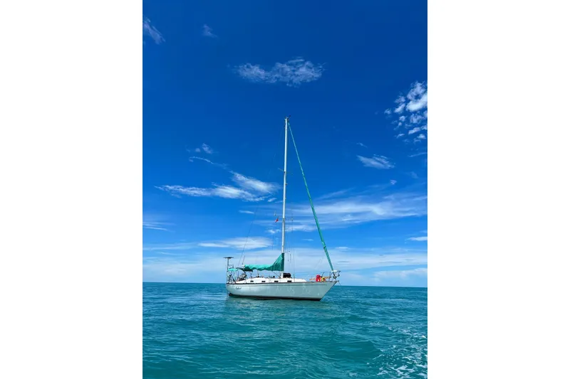 Slide: The Image of Sailboat Tartan 37 (1987) on calm ocean under clear blue sky. - 2