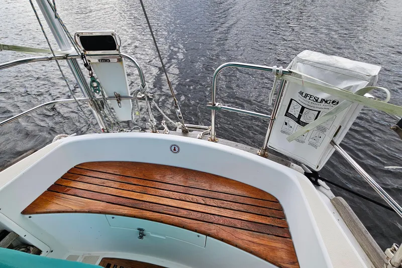 Slide: The Image of Cockpit of 1987 Tartan 37 sailboat with wooden seating and Lifesling safety equipment. - 24