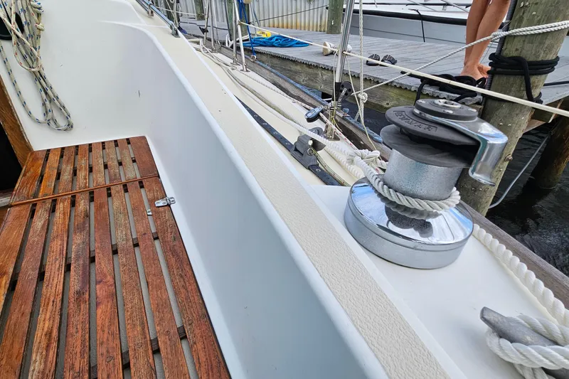 Slide: The Image of 1987 Tartan 37 sailboat deck with winch and wooden flooring. - 25