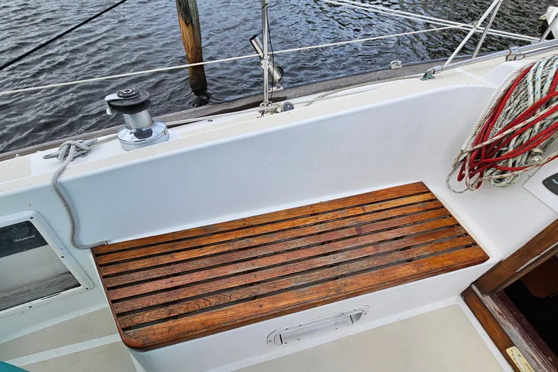 Slide: The Image of 1987 Tartan 37 sailboat cockpit with wooden seating and coiled ropes. - 27