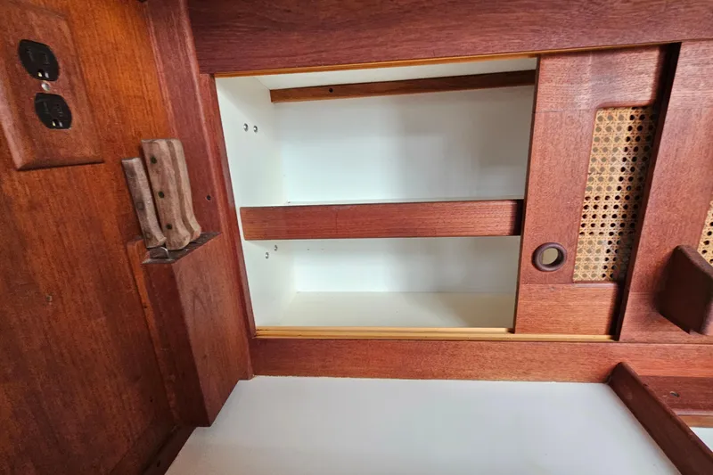 Slide: The Image of Interior of 1987 Tartan 37 sailboat with wooden cabinetry and knife holder. - 34