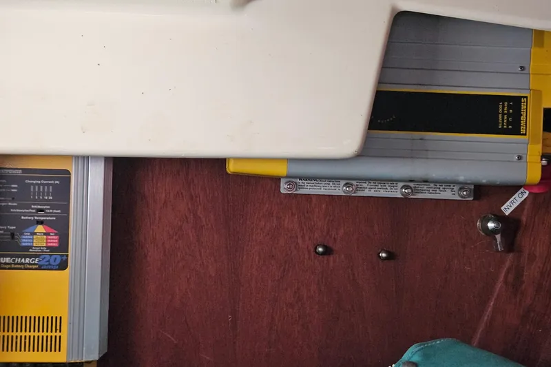 Slide: The Image of Battery chargers and inverter setup on a 1987 Tartan 37 sailboat. - 42