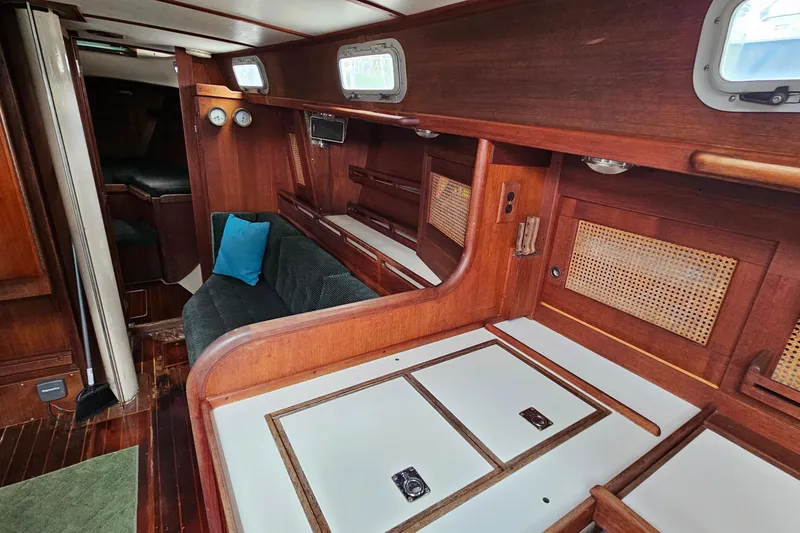 Slide: The Image of Interior of 1987 Tartan 37 sailboat with wood paneling and cozy seating area. - 45