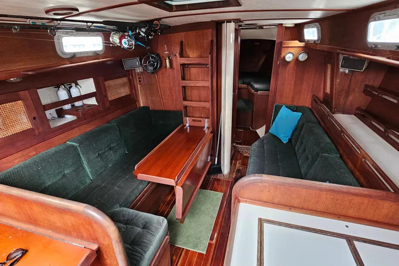 Slide: The Image of Interior of 1987 Tartan 37 sailboat with wooden furnishings and green seating. - 50