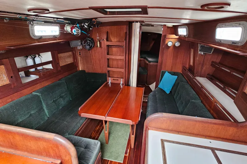 Slide: The Image of Interior of a 1987 Tartan 37 sailboat with wooden furnishings and green seating. - 51