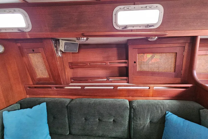 Slide: The Image of Interior of 1987 Tartan 37 sailboat with wooden cabinetry and cushioned seating. - 53